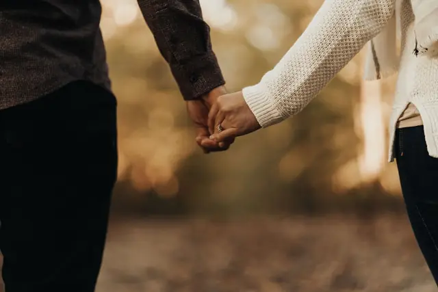 Two hands held, faces not shown